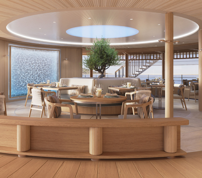 Amangati alira 03 1890x1167px | The Luxury Travel Atlas Elegant Circular Dining Area with Wooden Furnishings, Central Planter Tree, and Ocean-view Windows.