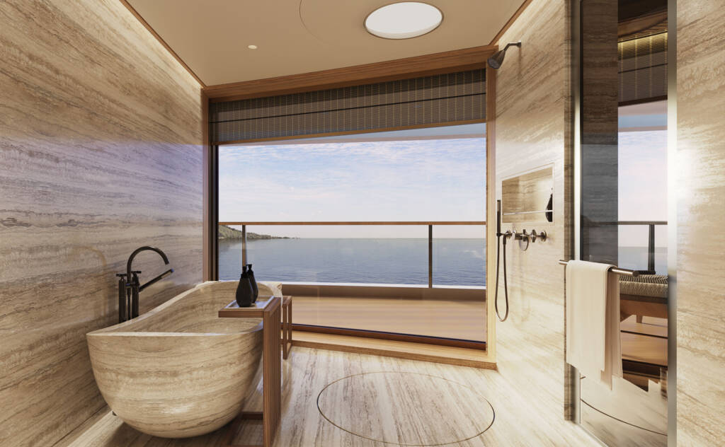 Luxurious marble bathroom with a freestanding tub facing a sea view through a large window.