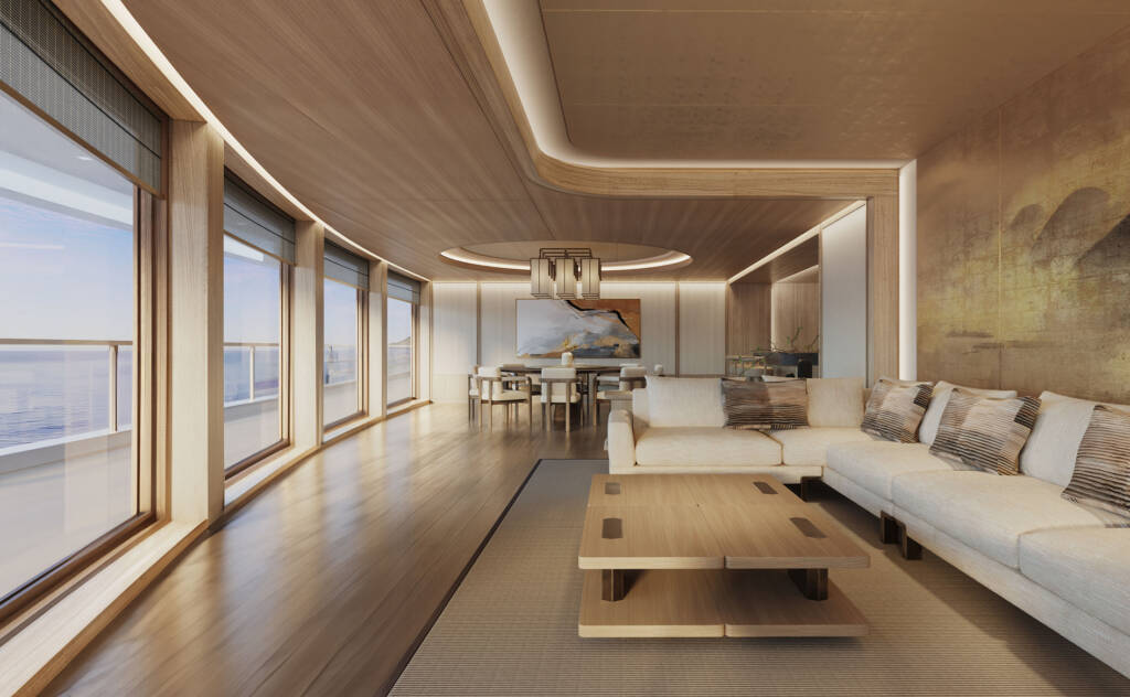 Spacious living area with beige sofa, wooden floors, and large windows overlooking the sea