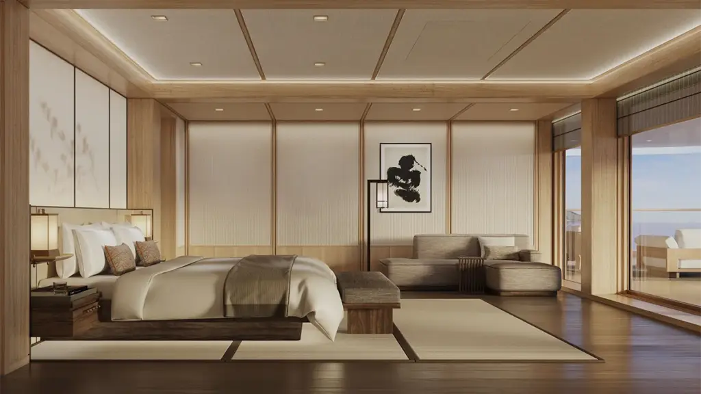 Japanese-inspired hotel suite with a low platform bed, neutral bedding, and a seating area near a large windowed wall.