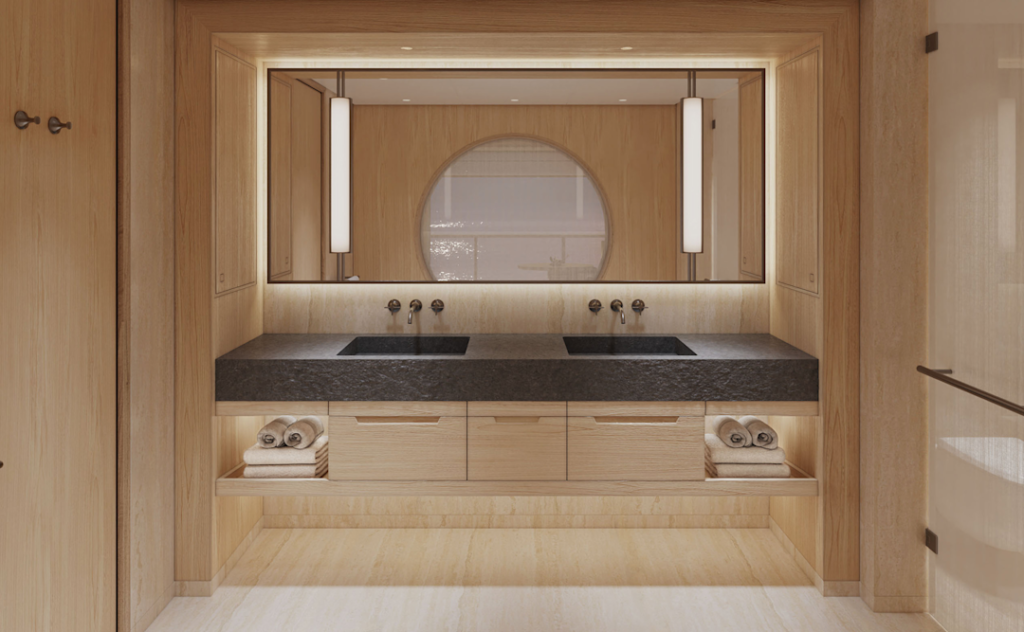 Wooden bathroom vanity with dual sinks, dark stone countertop, and a large backlit mirror