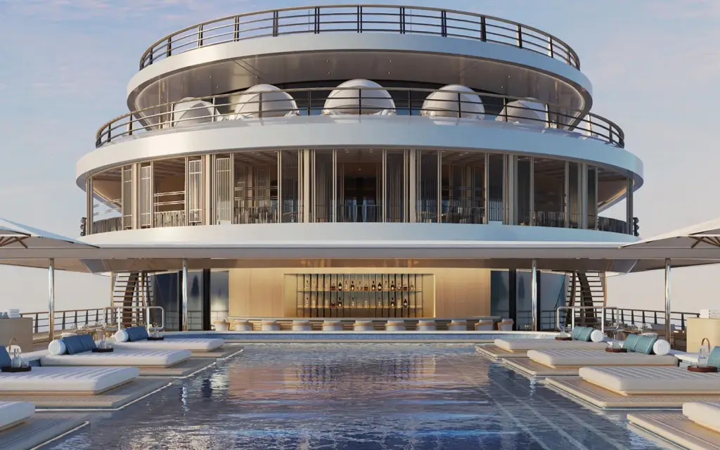Amangati pool deck 01 1394x1394px 1 | The Luxury Travel Atlas | The Luxury Travel Atlas a Luxury Yacht Pool Deck with a Circular Multi-level Structure Above, Row of White Sun Loungers Along the Pool, and a Bar at the Far End Under Shaded Canopies.