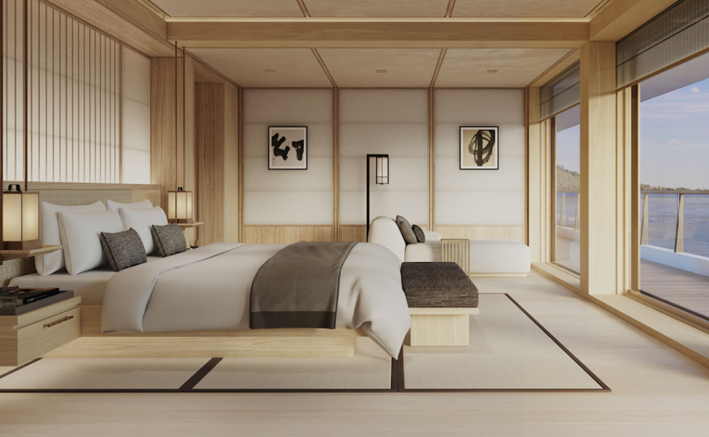 Wooden, minimalist bedroom with a low platform bed, neutral bedding, and floor-to-ceiling windows overlooking a lake.
