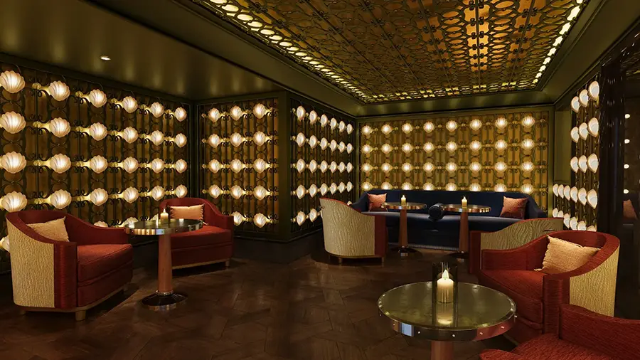 Luxurious Lounge with Warm Ambient Lighting, Red and Cream Chairs, Round Tables, and Wall of Globe-shaped Bulbs Surrounding the Room