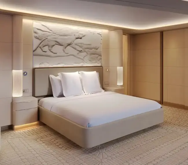 Luxurious Neutral-toned Hotel Bedroom with a Large White Bed, Soft Lighting, and Built-in Shelving on the Left.