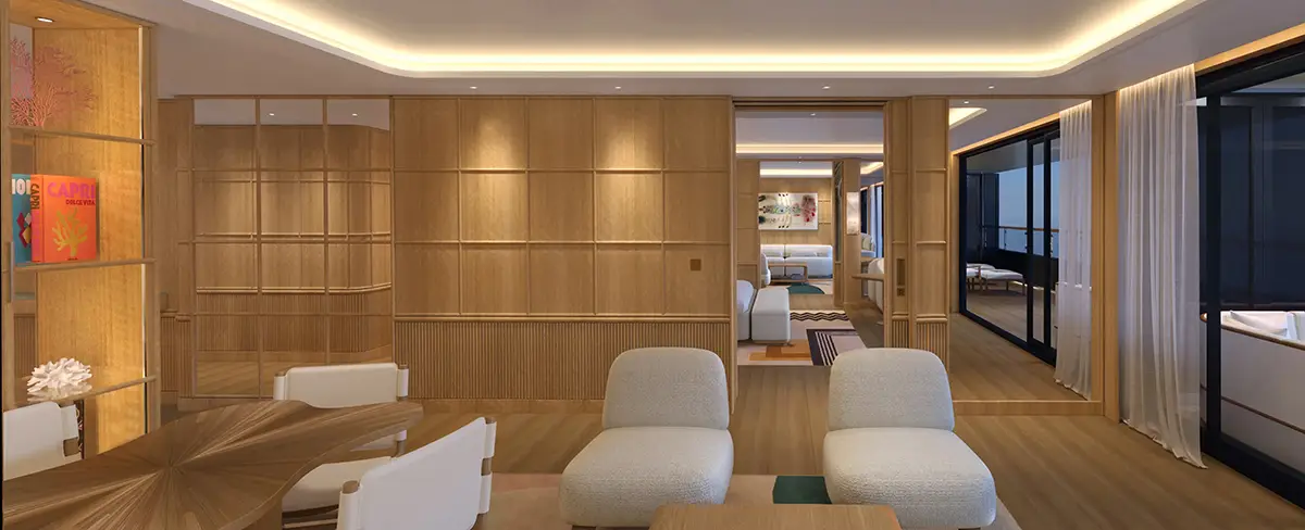 Open living area with wood-paneled walls, round wooden dining table, white chairs, and two cream lounge chairs.