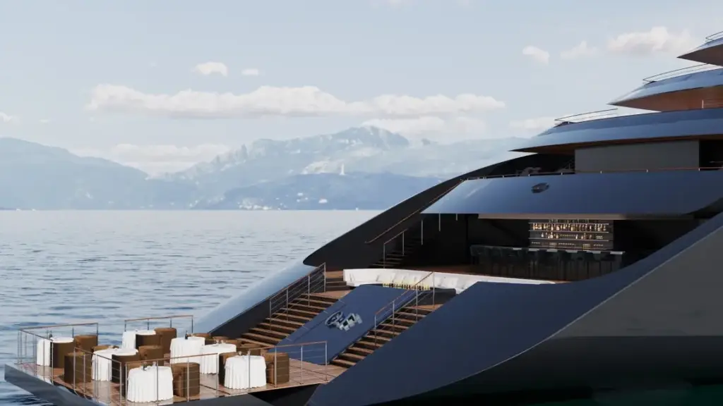 Luxurious yacht deck with white and brown seating, leading to a bar area against a calm sea and distant mountains.