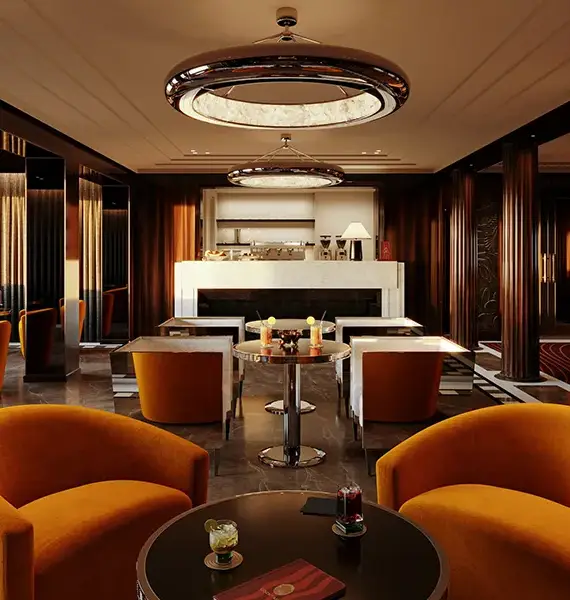 Orient Express Yachts Feature 01 | The Luxury Travel Atlas Luxurious Hotel Lounge with Orange Curved Chairs, Circular Tables, and a Marble Fireplace.