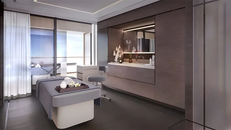 Modern Spa Treatment Room with a Padded Massage Bed, Folded Towels, and a Large Window View Outside.