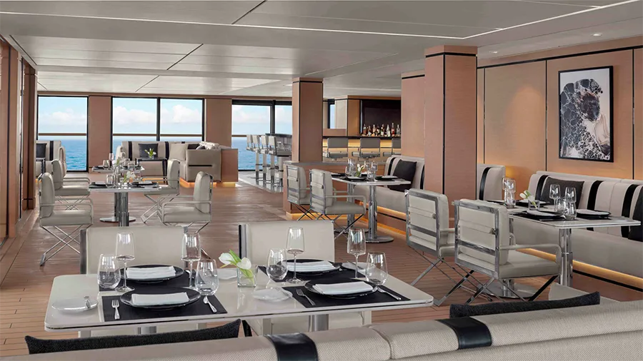 Elegant Cruise-ship Dining Room with White Tables Set for Four and Wine Glasses, Overlooking the Ocean Through Large Windows to the Left and Back.