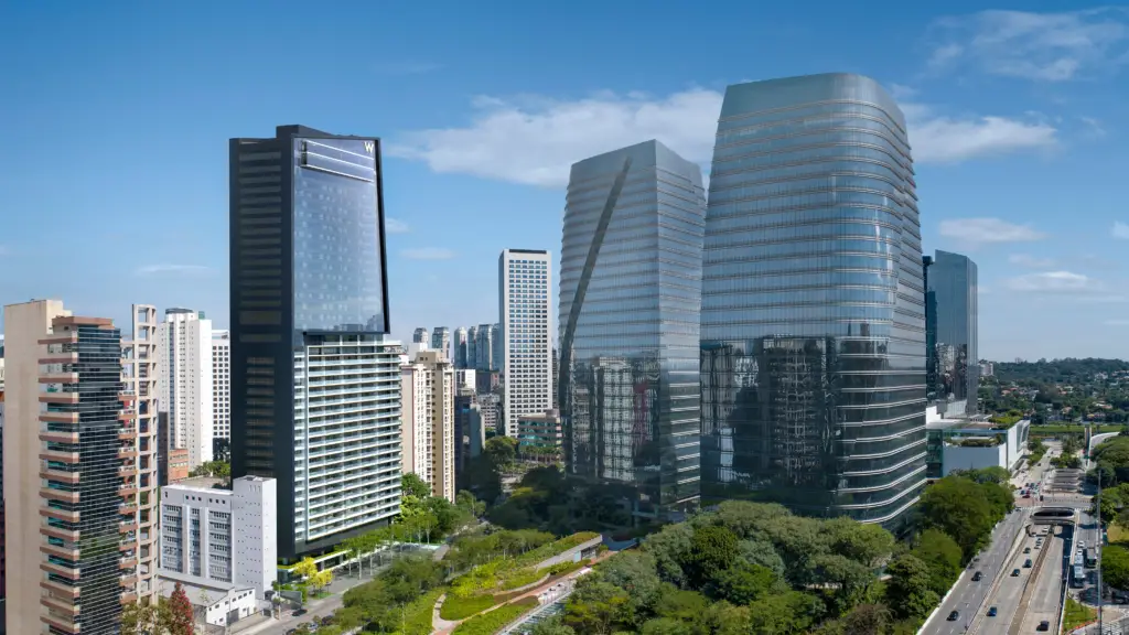 W Sao Paulo Hotel - City Skyline with Tall Glass Skyscrapers Against a Blue Sky, Featuring Modern Office Towers and Greenery Below, from an Elevated View.