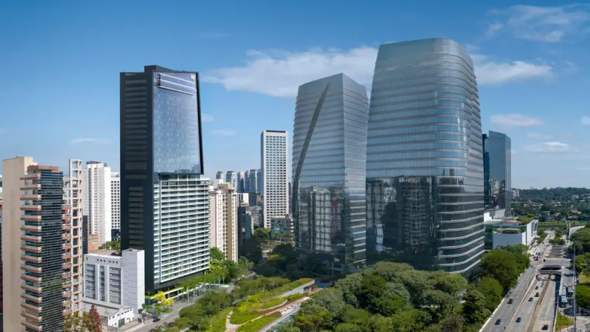W Sao Paulo Hotel - City Skyline with Tall Glass Skyscrapers Against a Blue Sky, Featuring Modern Office Towers and Greenery Below, from an Elevated View.